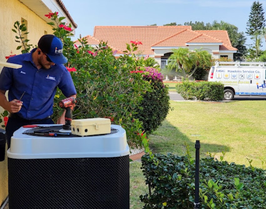 Hawkins Service Company technician installing AC unit in Tampa